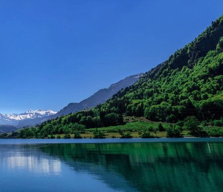 Mountain landscape with lake and blue sky in Alps, Switzerland.の写真素材