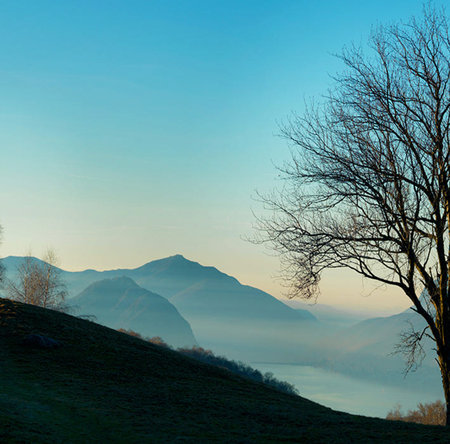 Foggy morning in the italian alps. Beautiful nature landscape.の写真素材