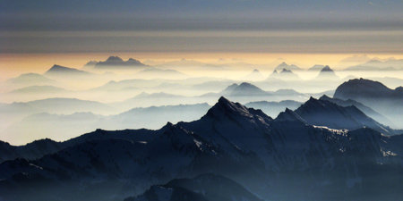 panoramic view of the mountains in the clouds at sunset.の写真素材