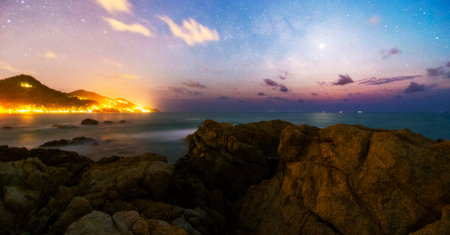 Night sky with stars and milky way over the sea. Long exposure.