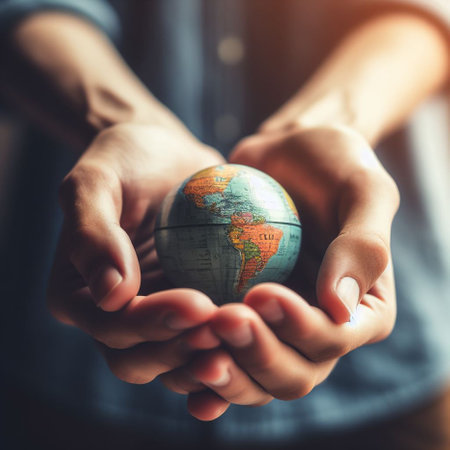 Close up of human hands holding a globe. Global business concept.の素材