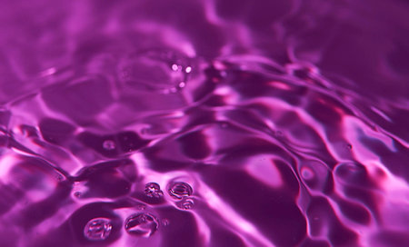 Purple water with ripples close-up. Abstract background.