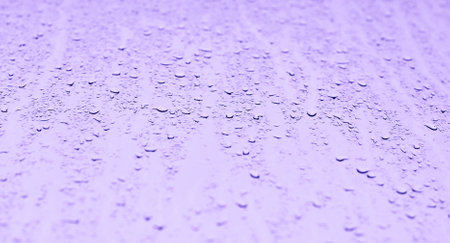 Water drops on the glass in purple tone. Abstract background and texture for design.