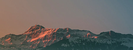Panoramic view of the snow-capped mountains at sunset