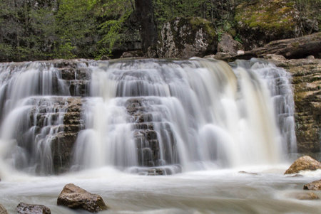 Waterfall in the forest. Waterfall on the mountain river.