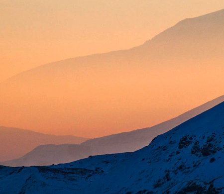 Snowy mountains in the evening light. Winter landscape. Caucasus, Russia.
