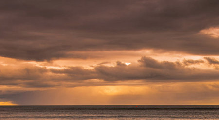 Cloudscape, Colored Clouds at Sunset near the Ocean on the Beach