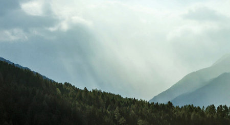 Mountain landscape with fog and sunbeams in the morning.