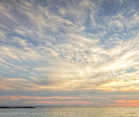 Sunset over the sea. Beautiful sky with clouds. Nature composition.