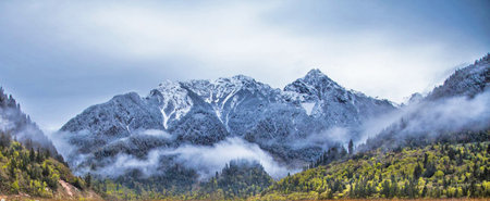 Panoramic view of snow-capped mountains in autumn.