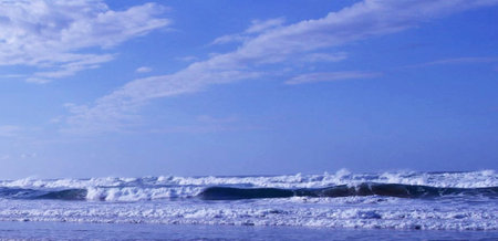 Beautiful beach with waves and blue sky, Bali, Indonesia