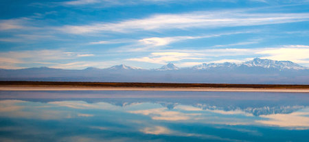 Mountains reflected in the lagoon of Laguna Colorada, Boliviaの写真素材