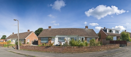 Pretty newly built homes and gardens against a clear blue summers sky. Stitched panoramic image detailed when viewed large.の写真素材