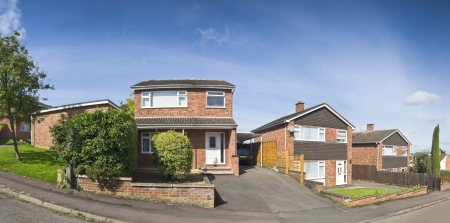 Pretty newly built homes and gardens against a clear blue summers sky. Stitched panoramic image detailed when viewed large.の写真素材