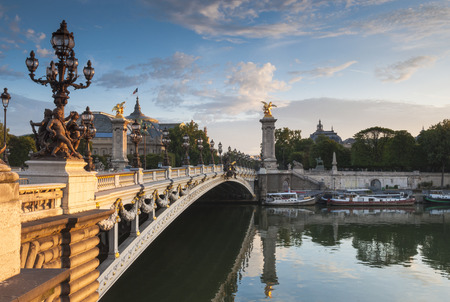 Grand Palais (1900) and opulent Pont Alexandre III bridge (1896) spanning the river Seine, Paris, France.の写真素材