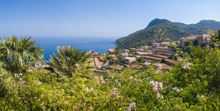 Traditional villa overlooking terraced vineyard and idyllic blue sea, Majorca, Spain.の写真素材