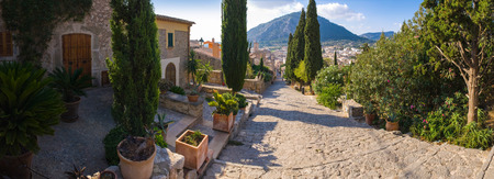 Hillside villas overlook traditional mediterranean view and mountains.