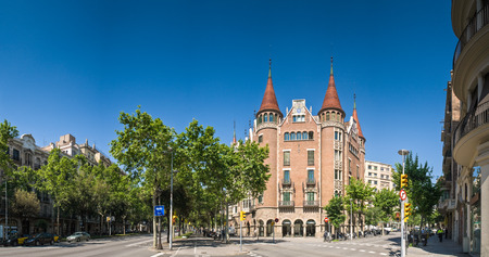 Fairy tale Modernista Gothic 'House of Spines' (built in 1903) framed by summer trees, Barcelona.のeditorial素材