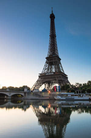 Iconic Eiffel Tower (1889) symbol of Paris reflected in the river Seine, still the tallest building in town standing at a mighty 1063 ft.の写真素材
