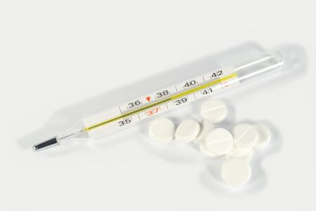 The clinical thermometer and white pills