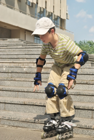 The boy practices to skate at the roller bladesの写真素材