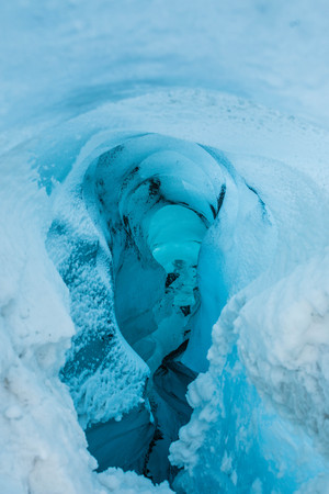 Blue ice cave hole glacier in Iceland
