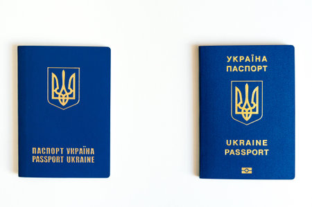 New ukrainian blue biometric passport with identification chip and old ukrainian passport on white backgroundの写真素材