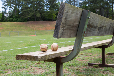 Baseball on a bench in a little league fieldの写真素材