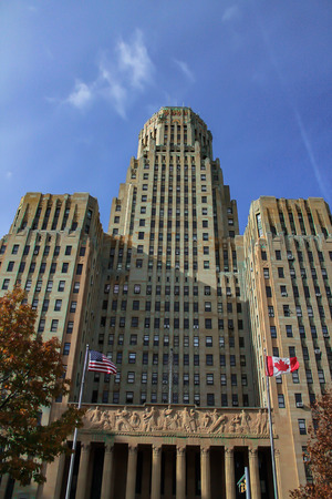 Daytime picture of Buffalo City Hall with McKinley Monument in the foreground and blue sky in the background.のeditorial素材