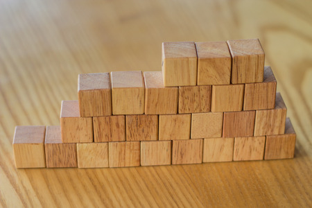 Building a wall from wooden bricks for construction or landscaping to create something with a...