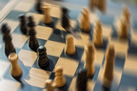 Blurred shot chess battle with all the focus on one pawn who is the hero in this scenario.  He will...