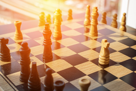 Chess battle with two competing teams and fighting in a game of clever wits with daylight sun glare.の写真素材