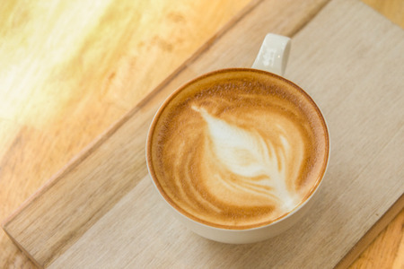 Get it while it's hot!  Angle downwards onto a blazing hot mocha latte made with fresh beans.  Let your brain wander as you start your morning routine and stay focused with this yummy and wonderful drink. Copyspace room.の写真素材