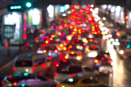 Blurred night life cityscape showing huge traffic jam and wasting fuel while people wait for the...