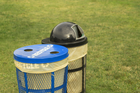 Trash bins in grassy park area for clean and neat concept with no garbage or litter.  Copyspace in green space.の写真素材