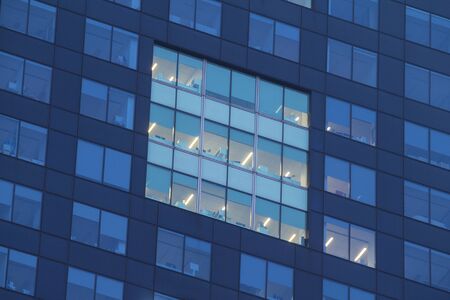 Apartment windows at night with lights for privacy concept.