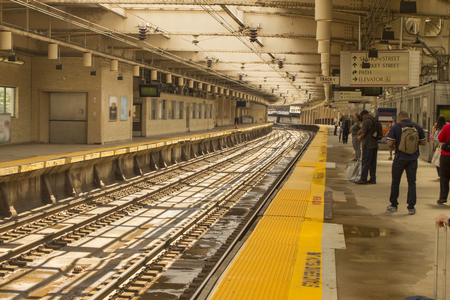 Waiting for light rail train on tracks for travel and transit concept.のeditorial素材