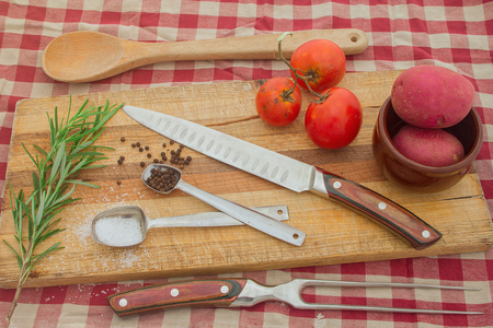 Spices and knives and food with cooking ingredients for recipe concept.の写真素材