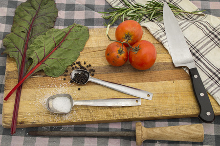 Knife and cooking utensils on cutting board for steak home meal idea preparation concept.の写真素材