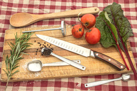 Knife on cutting board for meal preperation ideas in kitchen and home cooking.の写真素材