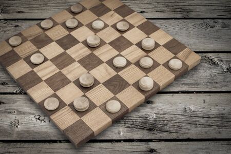 Wooden old style checkers business competition finance industry a game of numbers.  Copy space for...