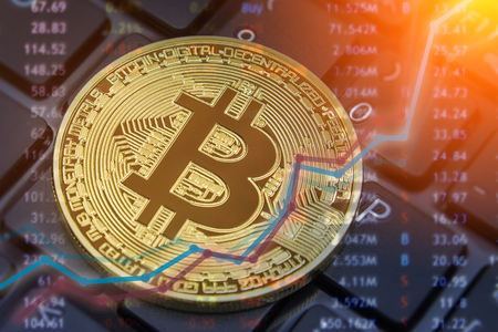 Bitcoin and dollar.  BTC market symbol cryptocurrency rising above the united states dollar.  Gold metal bitcoin on top of paper currency.  Copy space for text and wording.の写真素材