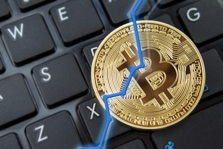 Bitcoin currency and dollar.  BTC market symbol cryptocurrency rising above the united states dollar.  Gold metal bitcoin on top of paper currency.  Copy space for text and wording.の写真素材