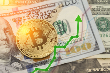 Bitcoin and dollar.  BTC market symbol cryptocurrency rising above the united states dollar.  Bitcoin on top of paper currency.  Copy space for text and wording.の写真素材