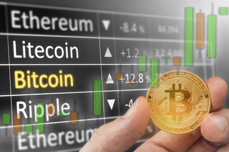 Bitcoin and dollar.  BTC market symbol and candles of cryptocurrency rising above the united states dollar.  Gold metal bitcoin on top of paper currency.  Copy space for text and wording.