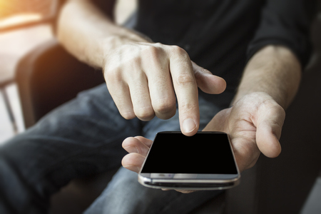 Mobile device in hands for business connected globally online through the internet.  Reliable fast data connection and network speeds.の写真素材