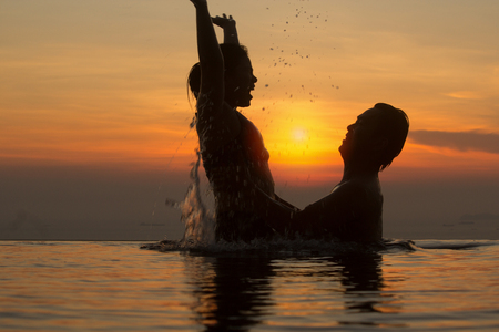 Faith and trust with strong warm feeling and emotional connection.  True love and romance with silhouette and sunset in background.の写真素材