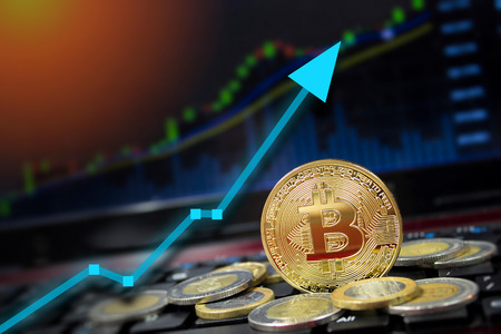 Bitcoin on computer laptop for investing and happiness for financial and business gain concept.  Green up arrow rising prices.の写真素材