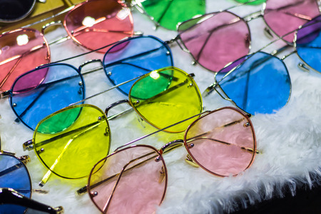Sunglass shop selling different bright colored funky glasses for UV protection from the sun.  Eye glass online store.の写真素材