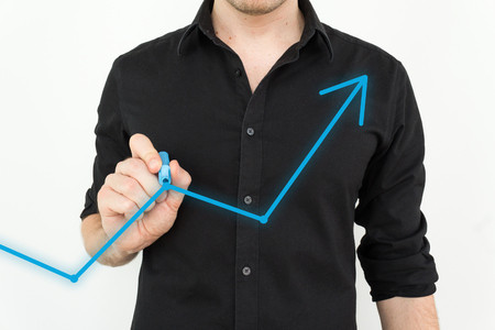 Stock market rise and fall with blue marker written on glass by man un business shirt.の写真素材